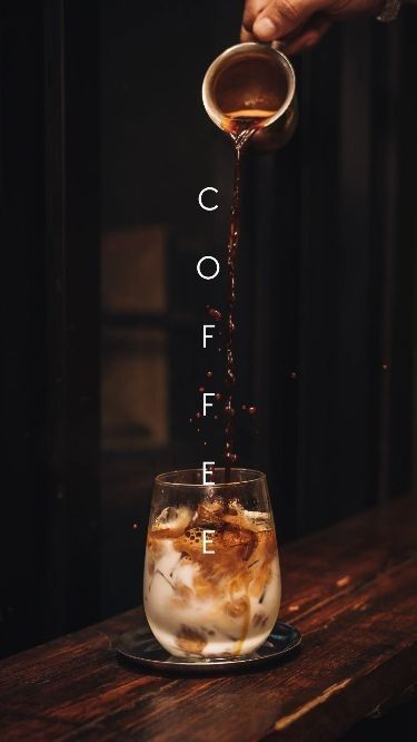 iced coffee being poured into glass with coffee splash